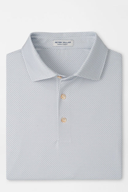 Folded light blue polo shirt with pattern on a white background