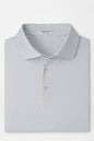Folded light blue polo shirt with pattern on a white background