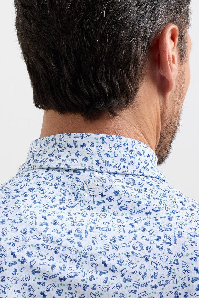 Man wearing a light blue shirt with a subtle pattern on a plain background
