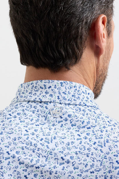 Man wearing a light blue shirt with a subtle pattern on a plain background