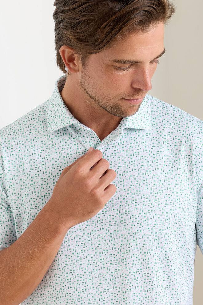 Man wearing a light blue patterned shirt against a neutral background