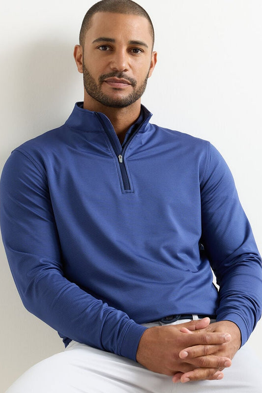 Man wearing a blue long-sleeve shirt against a plain background