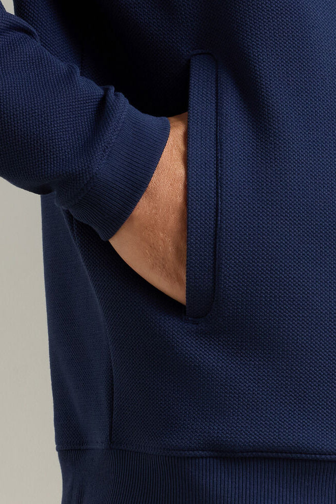 Navy blue hoodie with a neutral background