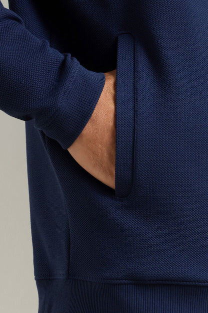 Navy blue hoodie with a neutral background