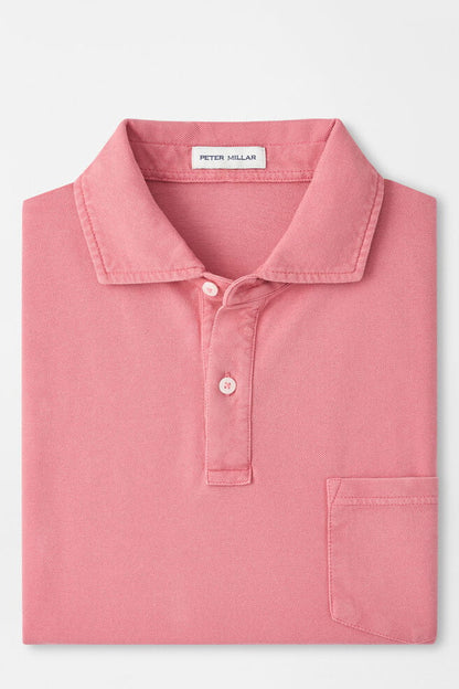 Pink polo shirt with 'Peter Millar' label on a light gray background