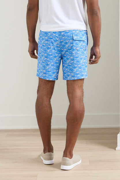 Person wearing blue patterned shorts on a plain background