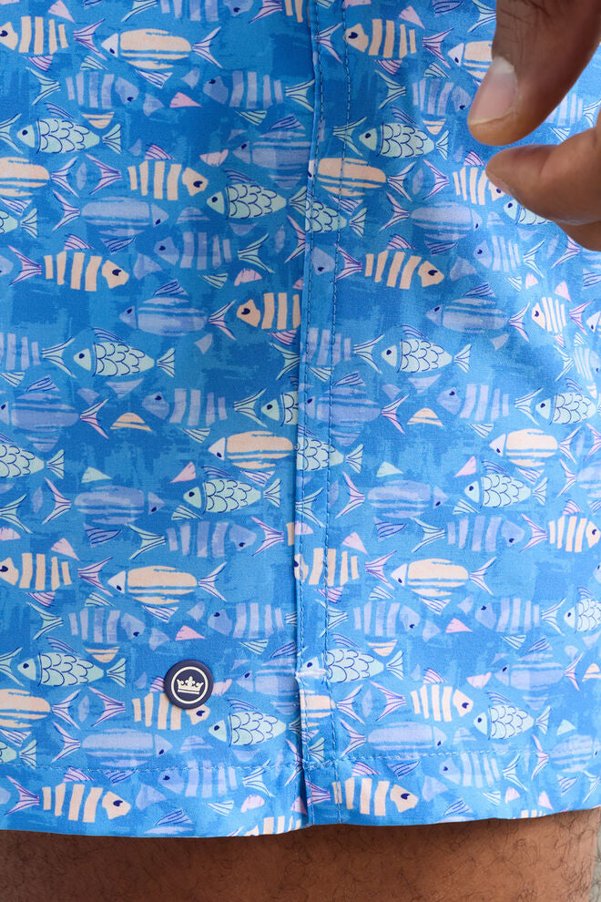 Blue shorts with fish pattern worn by a person