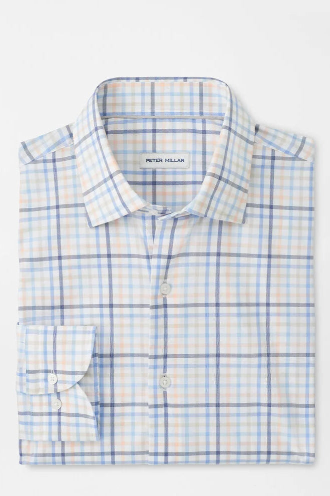 Folded blue and white checkered shirt with 'Peter Millar' branding on a white background