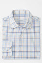 Folded blue and white checkered shirt with 'Peter Millar' branding on a white background