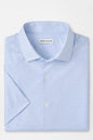 Blue patterned shirt with Peter Millar label on a light gray background