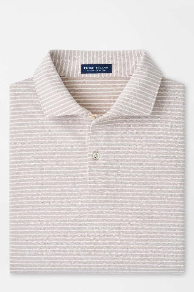 Folded striped polo shirt with a brand label on a white background