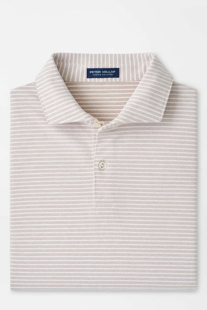Folded striped polo shirt with a brand label on a white background