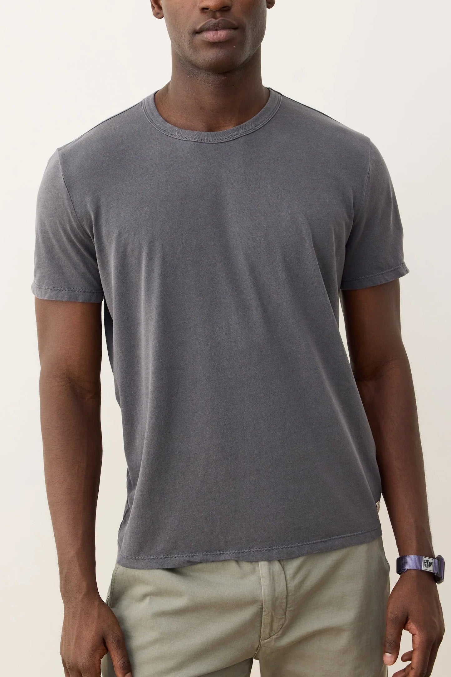 man wearing gray t shirt with tan pants
