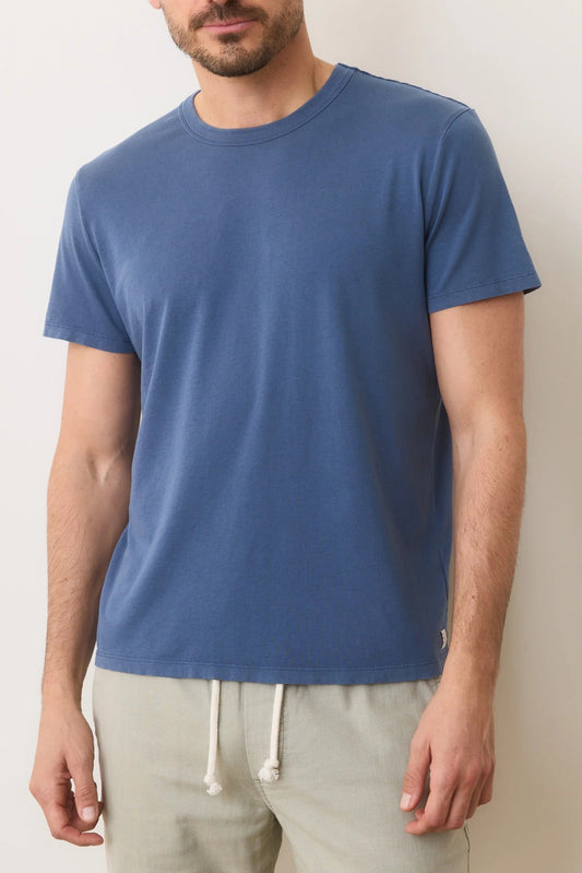 man wearing blue shirt against white background