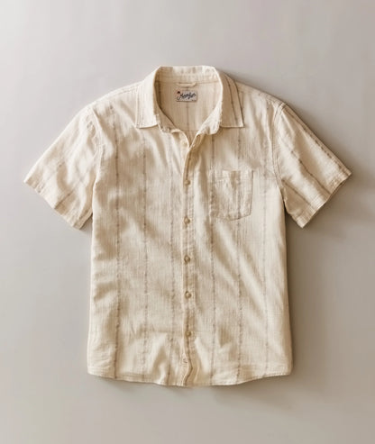 Beige short-sleeve shirt on a light gray background