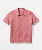 Pink polo shirt with white trim on a light gray background