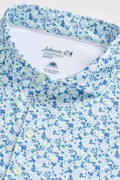 Close-up of a blue and white floral patterned shirt with 'Johnnie-O' branding.