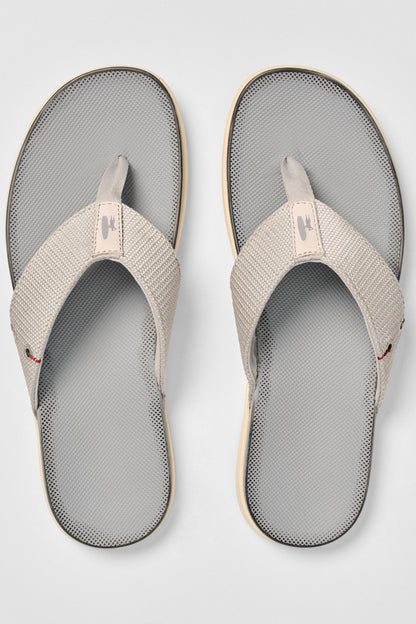 Pair of gray and beige sandals on a light gray background