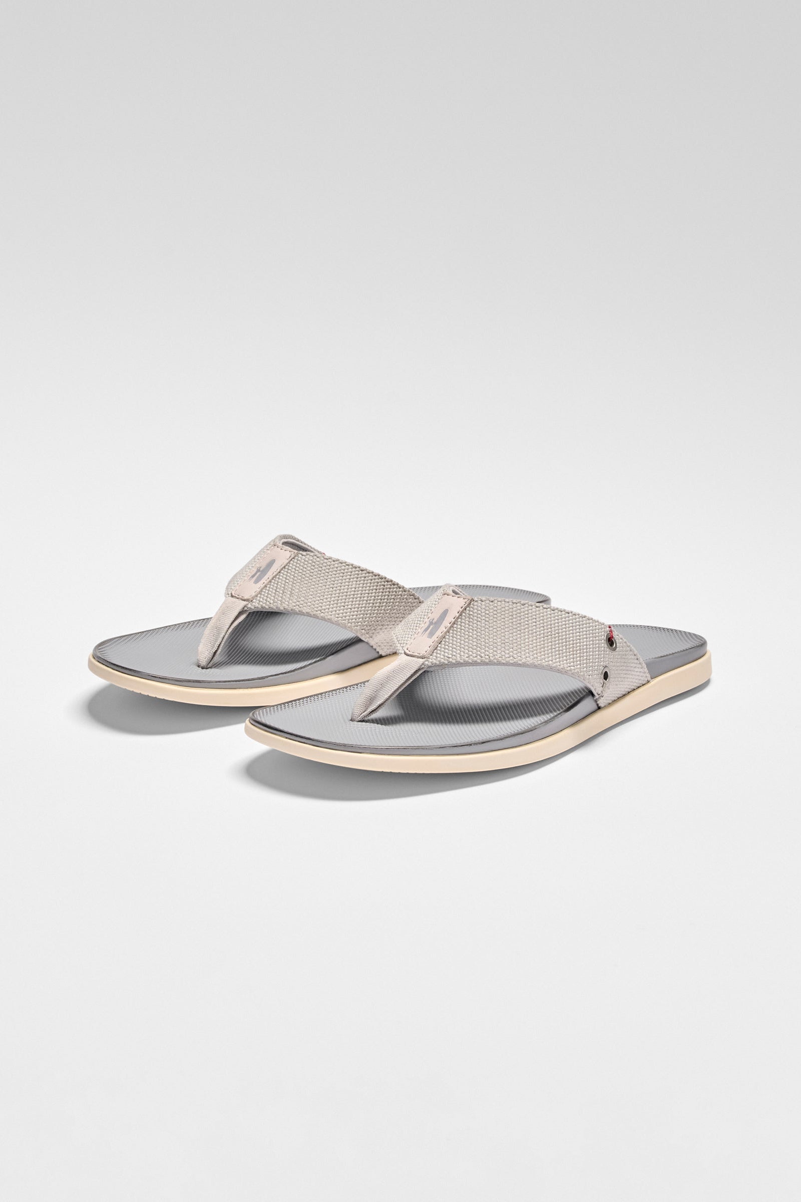 Pair of gray sandals on a light gray background