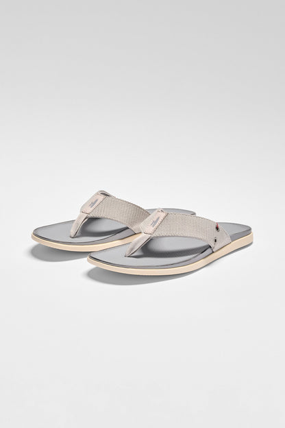 Pair of gray sandals on a light gray background