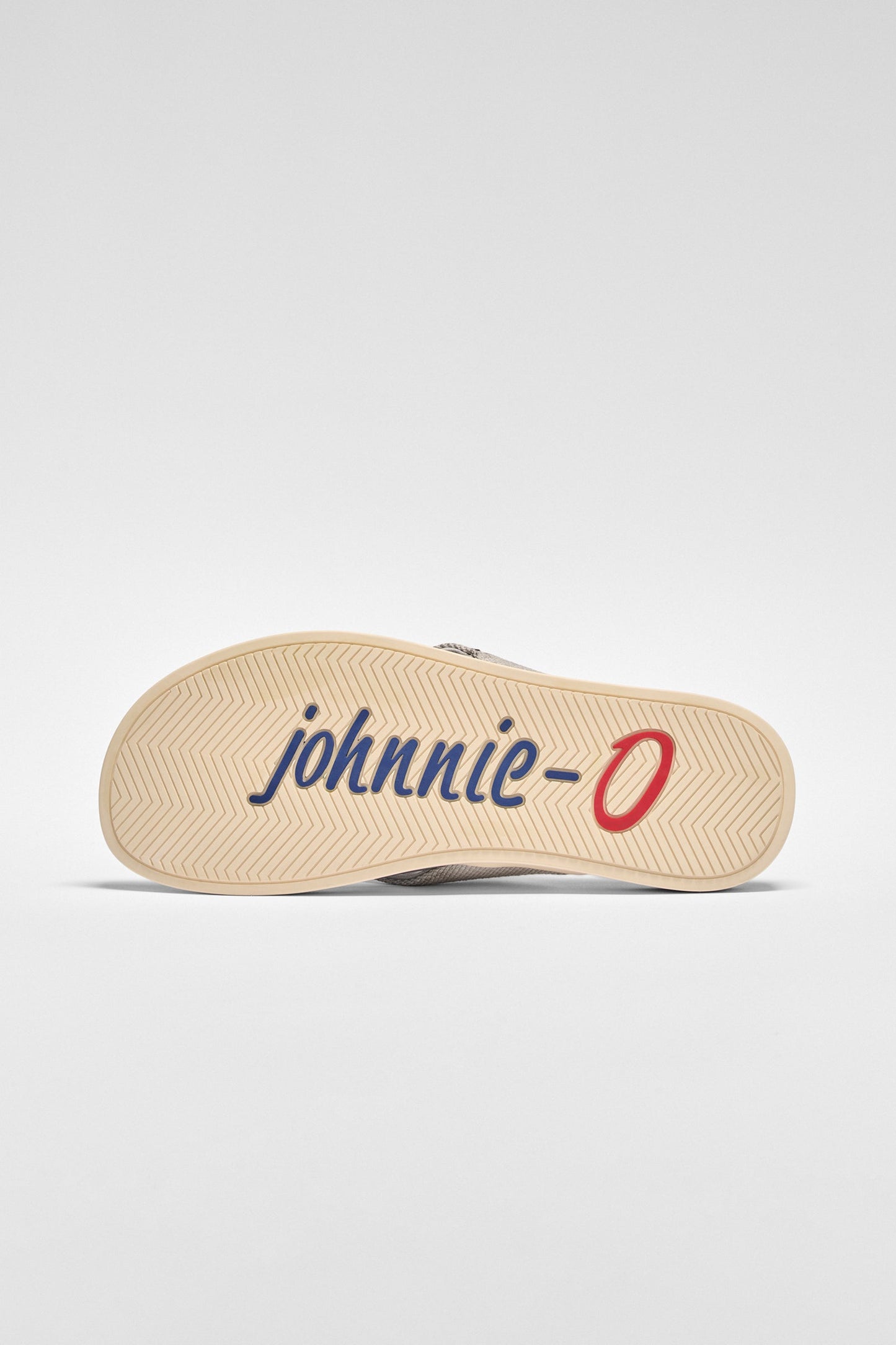 Sandal with 'johnnie-O' branding on a light gray background
