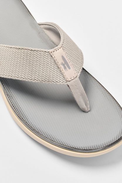 Gray sandal with a brand logo on a light gray background