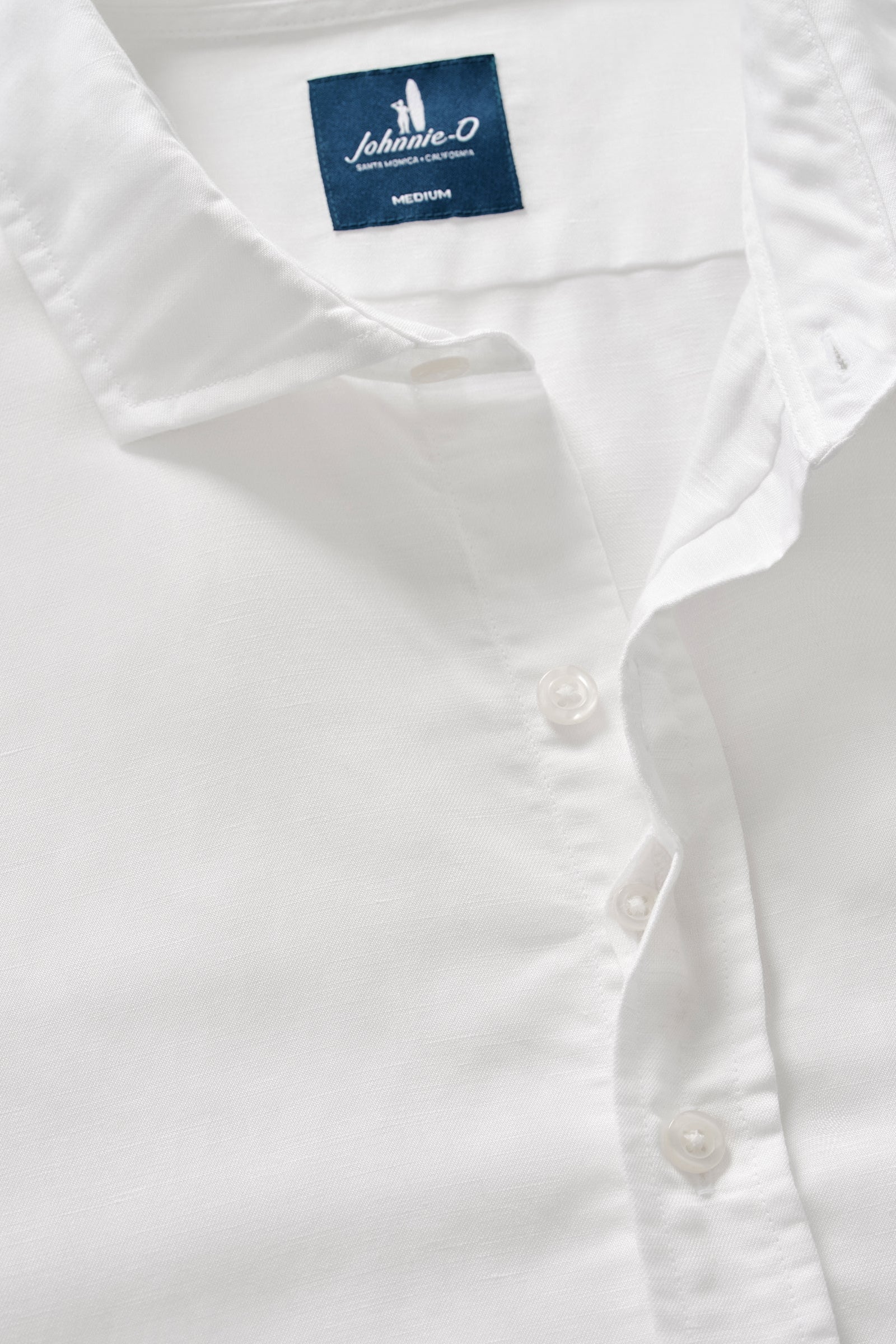 White shirt with a Johnson & Johnson label on a light gray background