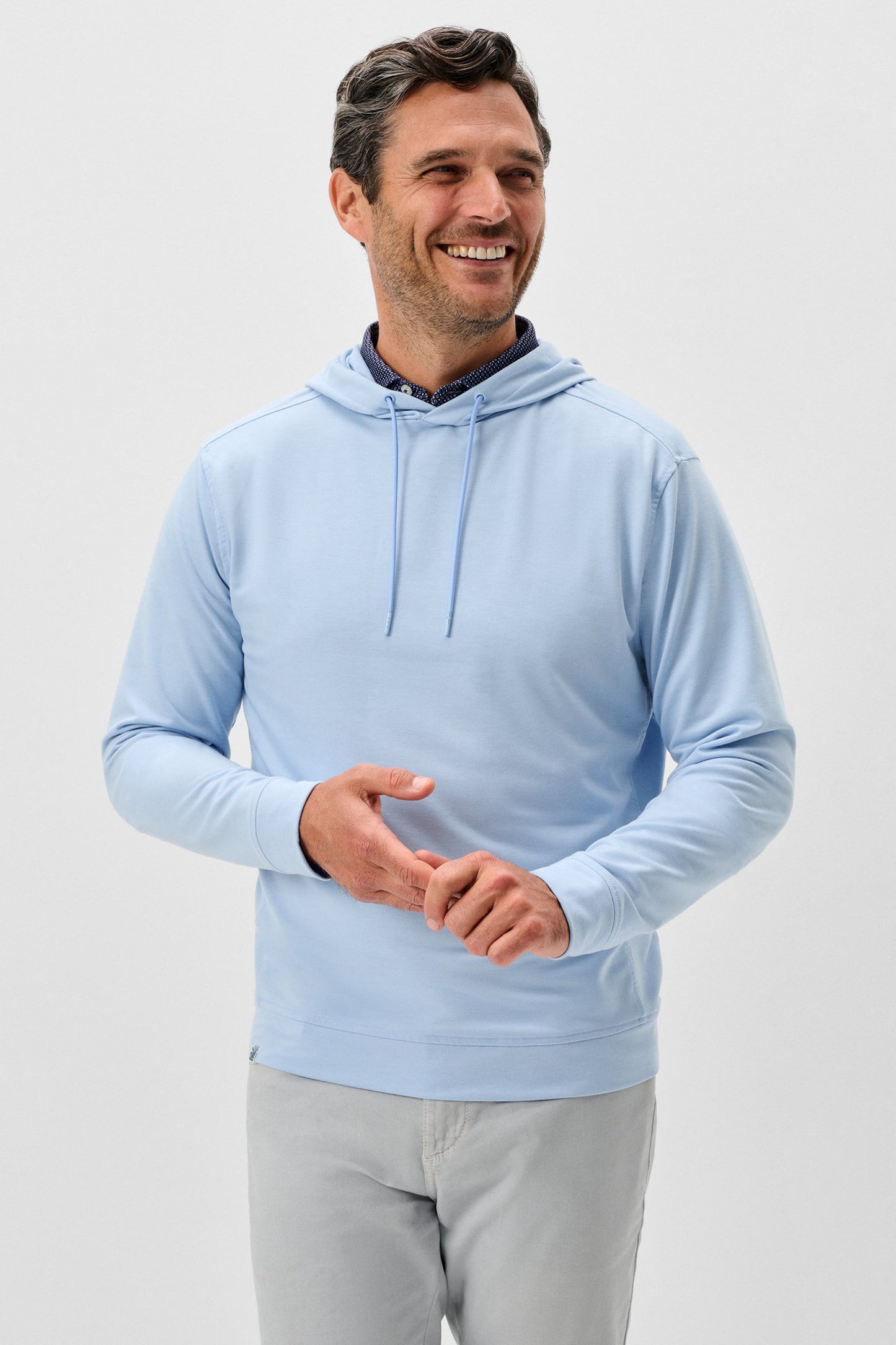 Man wearing a light blue hoodie on a white background