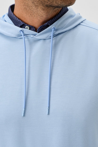 Light blue hoodie with a zipper detail on a neutral background