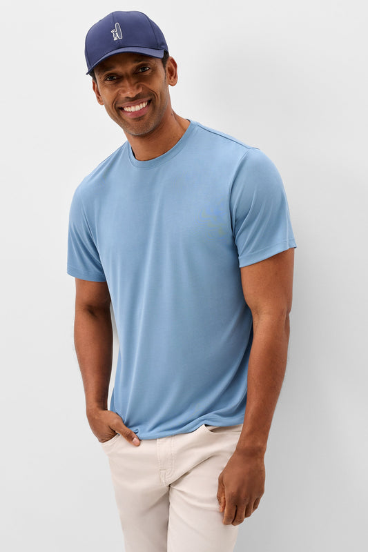 Man wearing a blue t-shirt and cap on a plain background