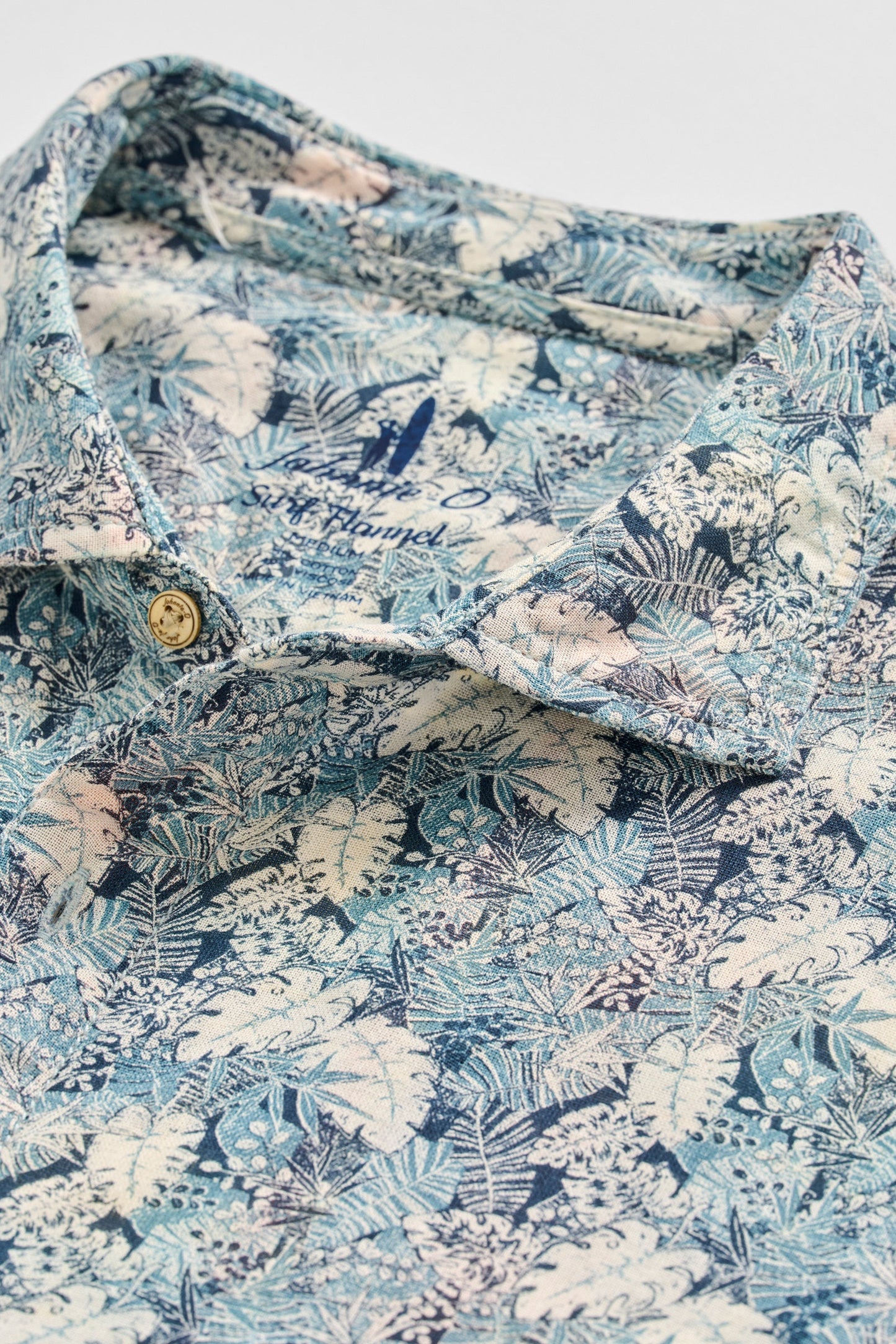 Floral patterned shirt with a brand name on a light background