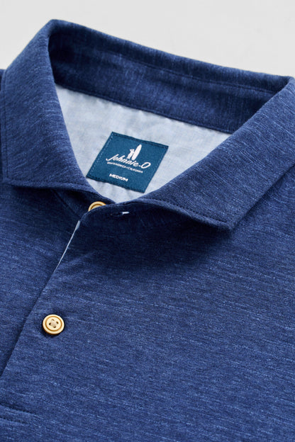 Close-up of a blue polo shirt with a brand label on the collar.