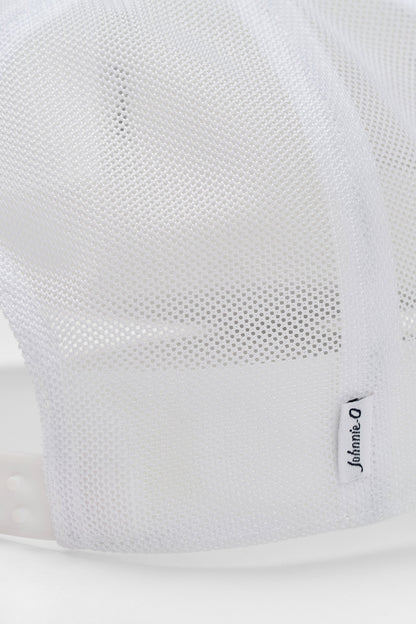 Close-up of a white sneaker with mesh design and brand logo on a light gray background