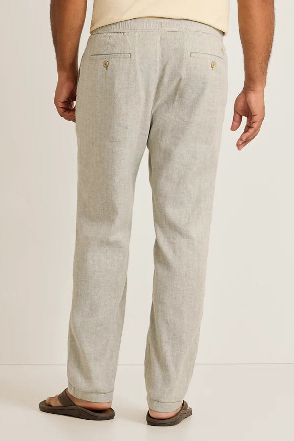 Light gray pants worn by a person on a white background