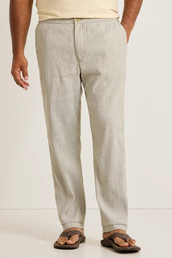 Light gray pants worn by a person on a white background