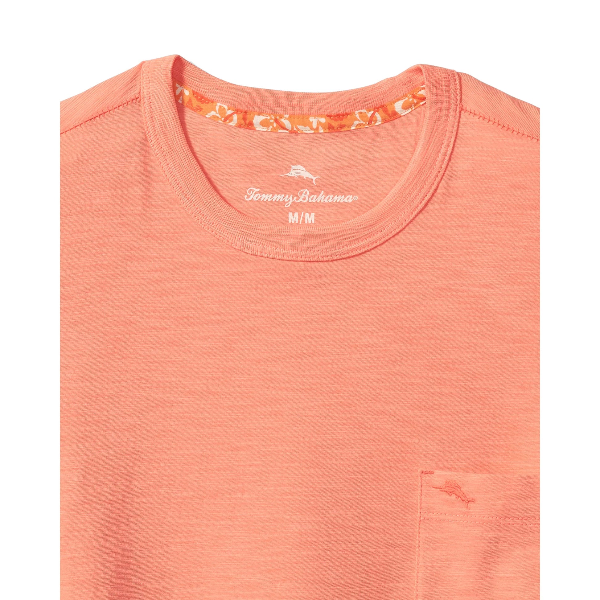 Coral-colored shirt with Tommy Bahama logo on a white background