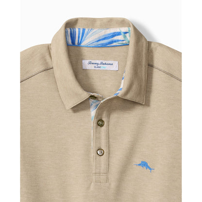 Beige polo shirt with floral collar and Tommy Bahama logo on a white background