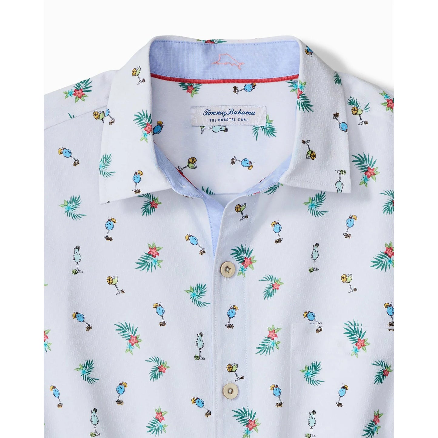 White shirt with colorful tropical pattern and Tommy Bahama label on a white background