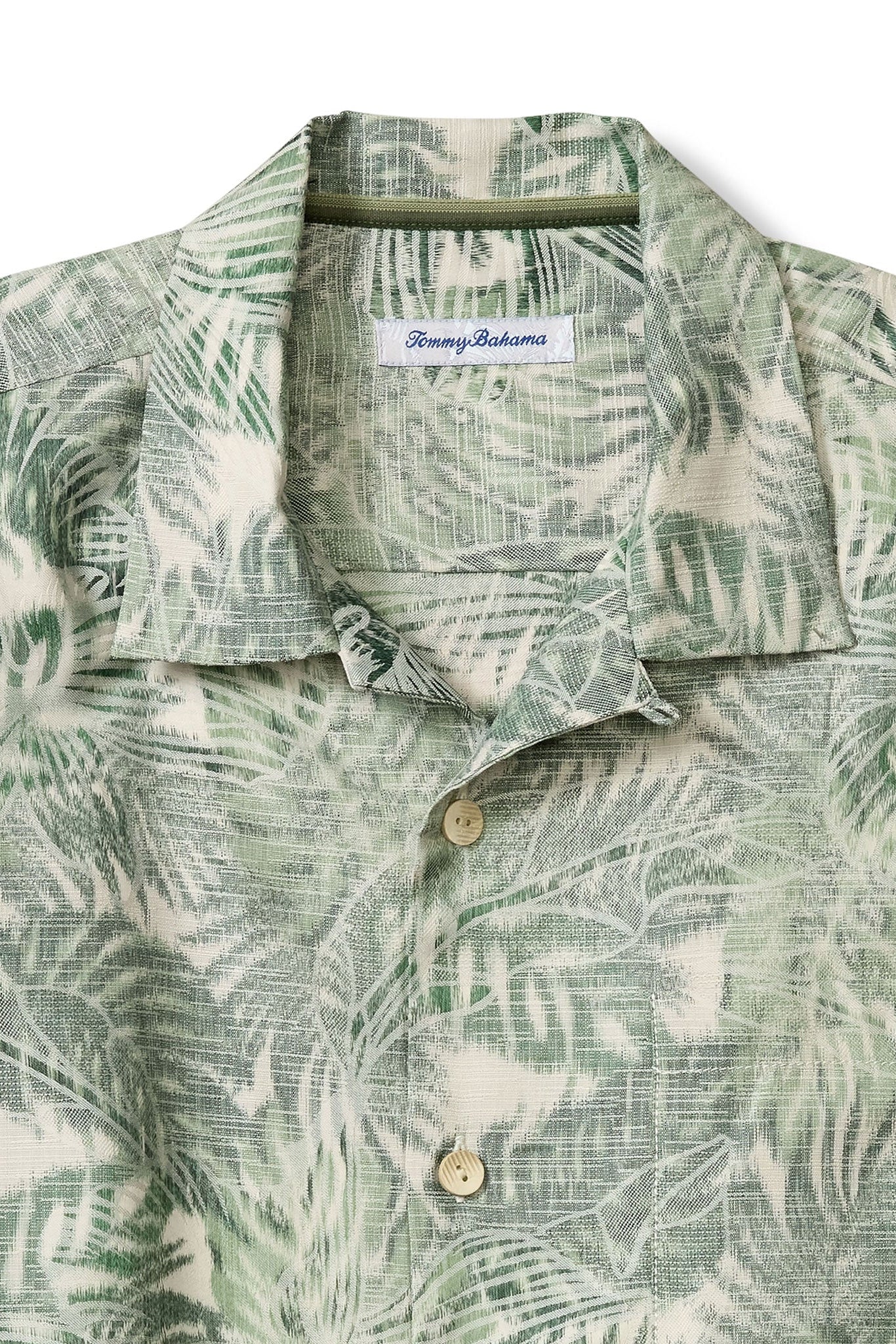 Green and white patterned shirt with Tommy Bahama label on a white background