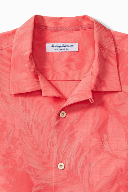 Coral patterned shirt with Tommy Bahama label on a white background