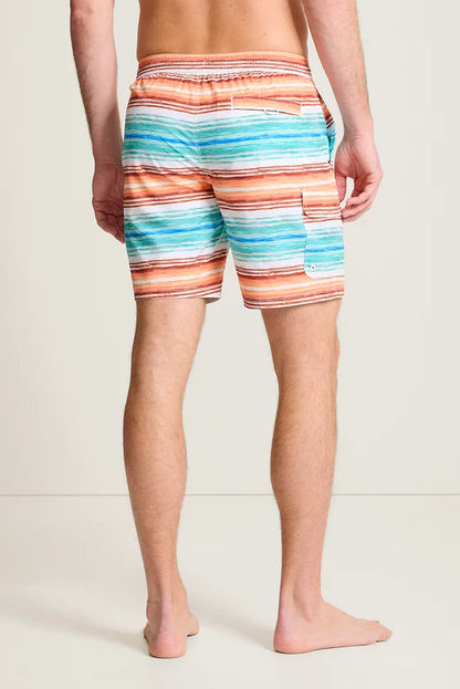 Person wearing colorful striped swim shorts on a plain background