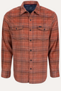 A long-sleeve button-up flannel shirt in a rust-orange and brown plaid pattern, featuring two buttoned chest pockets, displayed on a clean off-white background.