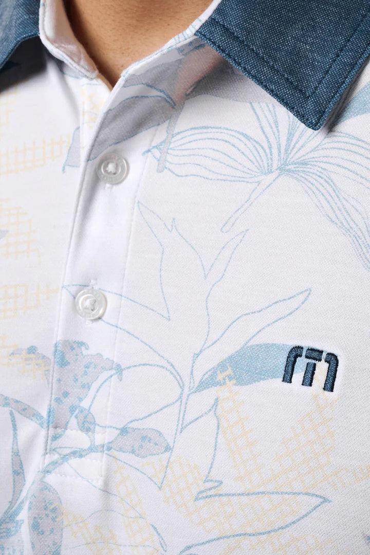 Close-up of a patterned shirt with a brand logo on a white background