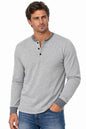 man wearing henley shirt and jeans