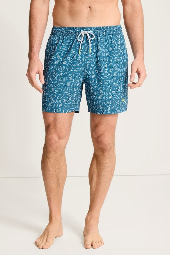 Person wearing blue patterned swim shorts on a white background