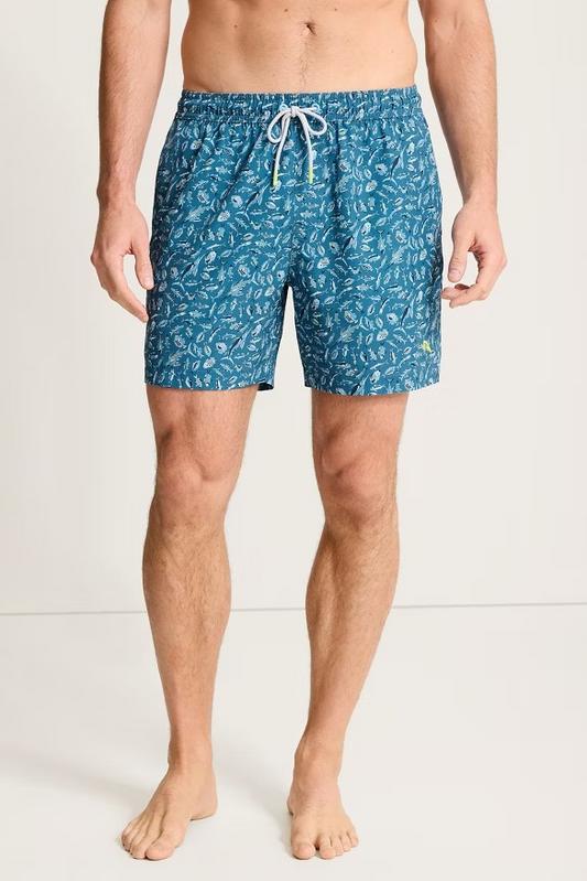 Person wearing blue patterned swim shorts on a white background