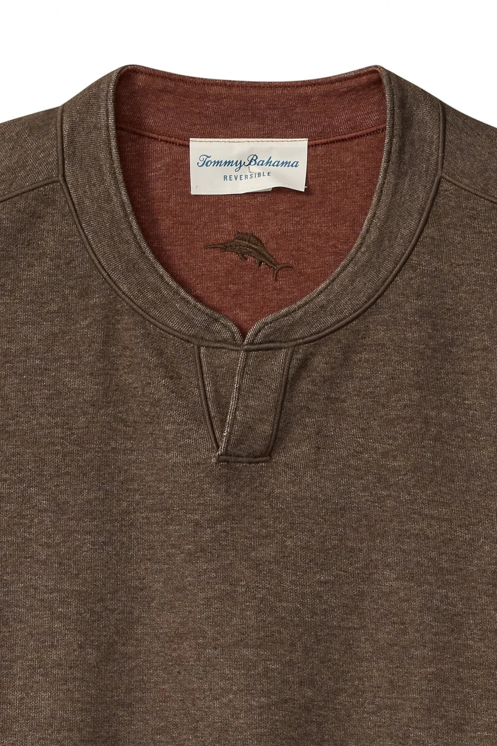 Close-up of a Tommy Bahama heather brown henley shirt with a contrasting rust-colored inner collar and a white brand label.