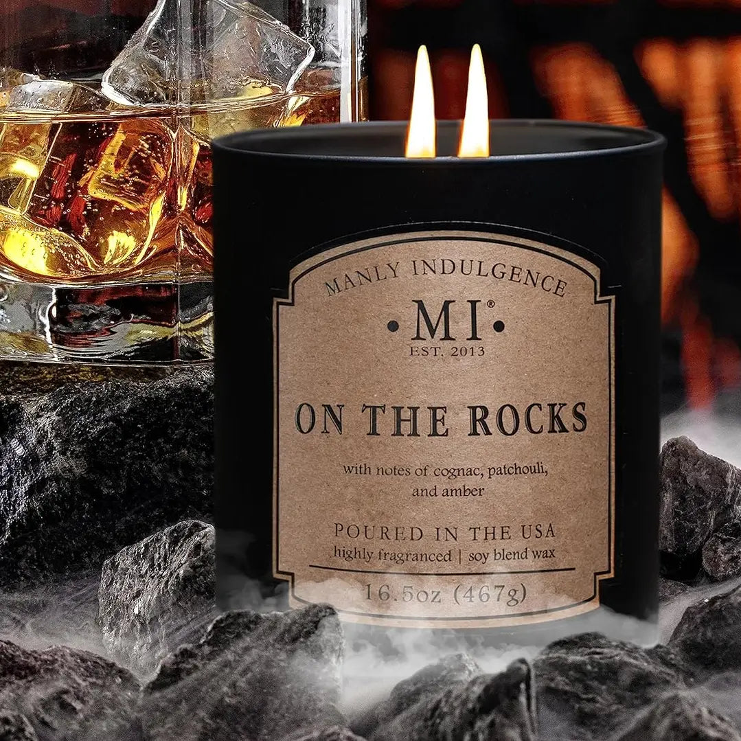 Candle labeled 'On the Rocks' with a glass of whiskey and ice in the background.