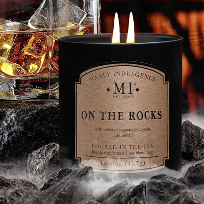 Candle labeled 'On the Rocks' with a glass of whiskey and ice in the background.