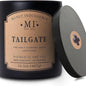 Candle with 'Manly Indulgence' label and 'Tailgate' description on a white background